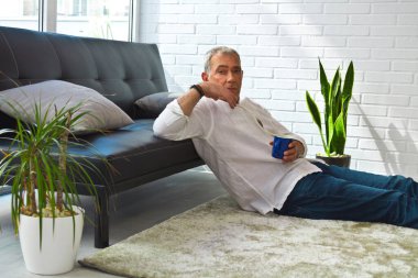 mature man with phone and surprise gesture