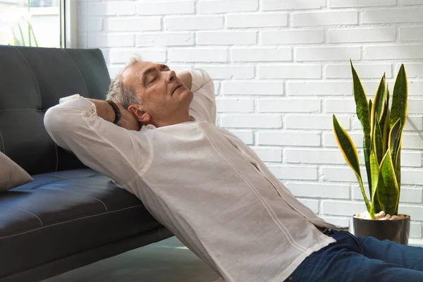 satisfied man relaxing in his living room