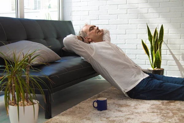 satisfied man relaxing in his living room