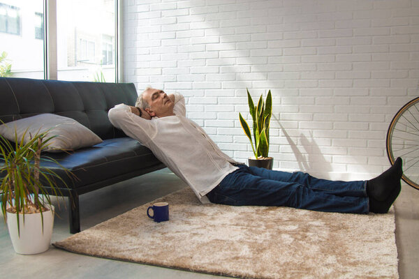 satisfied man relaxing in his living room