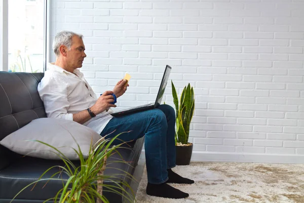 man with card and laptop at home or workplace