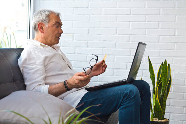 middle-aged man with laptop and credit card