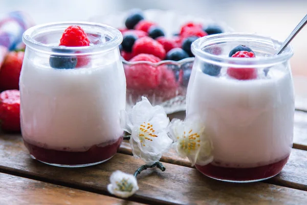 ahududulu yoğurt ve ahşap arka planda yaban mersini.