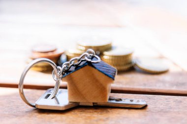 İpotek ya da emlak konsepti. anahtarlar, madeni paralar ve ev anahtarlığı