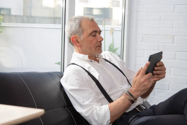 relaxed hipster man using digital tablet