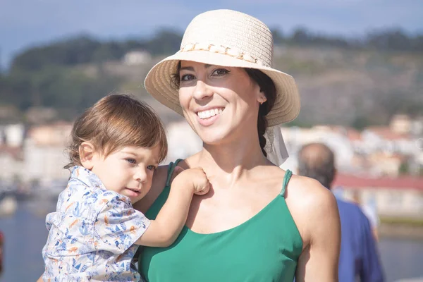 Anne kucağında küçük bir çocukla.