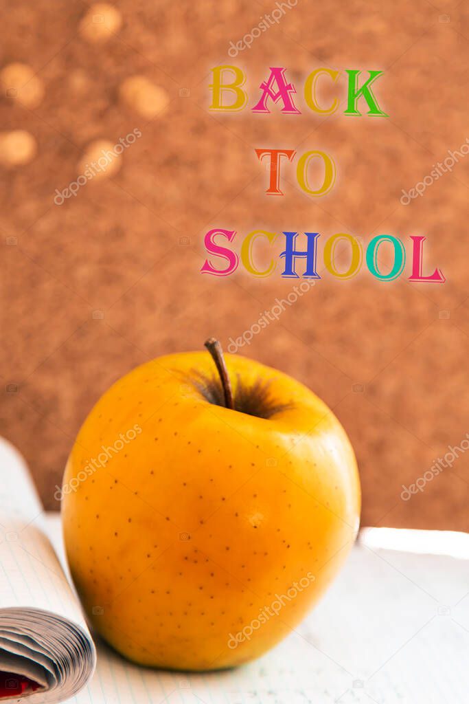 back to school concept with apple, cork and school supplies