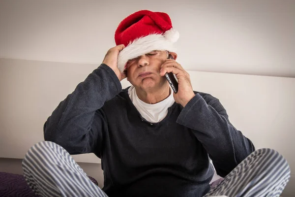 man overwhelmed with phone at christmas