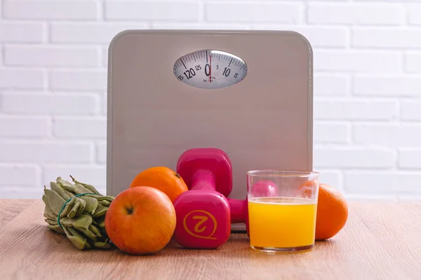 scale, fruits, vegetables, dumbbells and tape measure. diet, nutrition and sport concept
