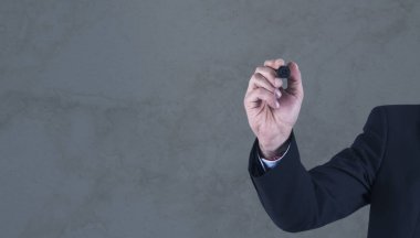 Duvara kalem çizen bir iş adamı.