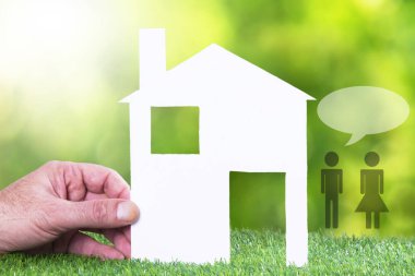 hand with house and silhouette with speech bubble. couple and house concept
