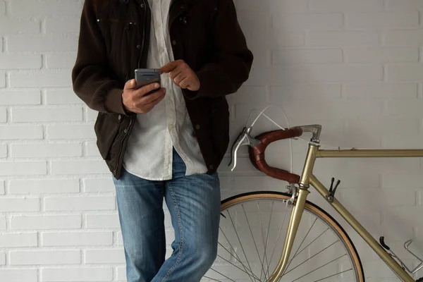 man with mobile phone and bicycle