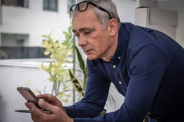 adult man chatting with mobile phone at home