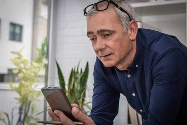 adult man chatting with mobile phone at home