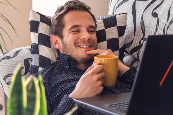 Happy Attractive Man Having Coffee Consulting His Laptop Home — Fotografia de Stock