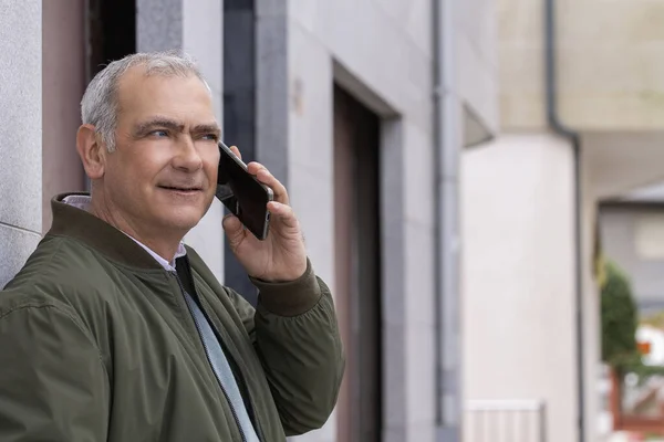 adult man on the street talking on the mobile phone