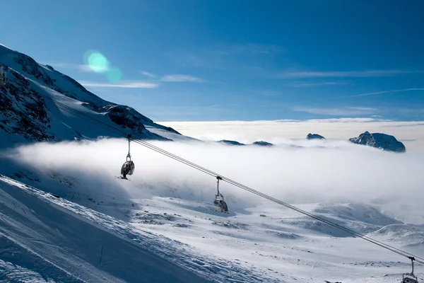 Ski lifts above the clouds — Stock Photo, Image