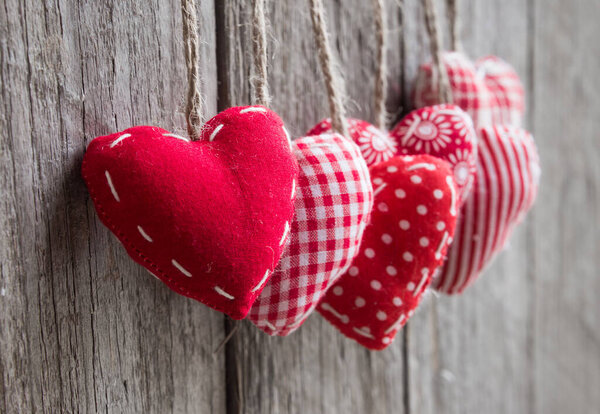 heart shaped red pillows on wooden background