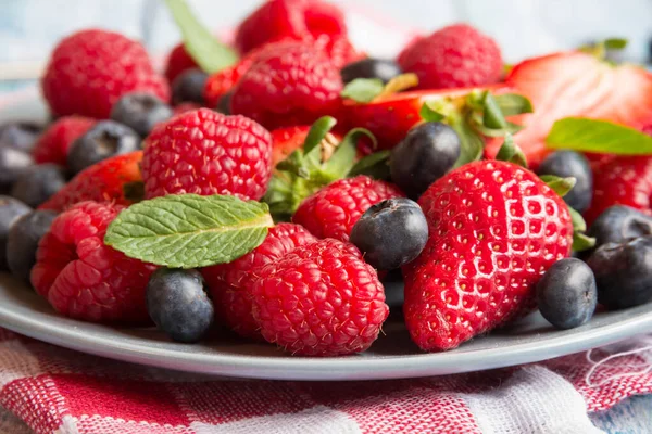 Taze meyveler ve olgun çilekler bir tabakta