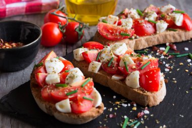 Domatesli bruschettalar, mozzarella ve fesleğen