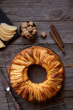 Dilimlenmiş elma ve kahverengi şekerli ev yapımı lezzetli elmalı turta