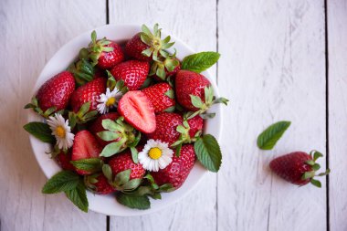 Yapraklı ve çiçekli taze çilekler.