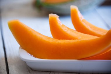 Tahta masada taze dilimlenmiş kavun.