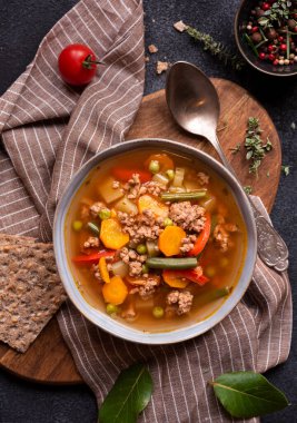 Ahşap arka planda sebzeli domates çorbası ve otlar. seçici odak.