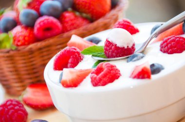 fresh strawberries with berries in a bowl on a wooden table
