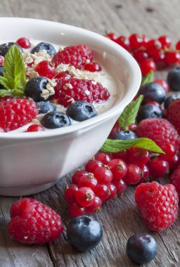 Beyaz tabakta ahududu ve yaban mersini ile taze meyveler.