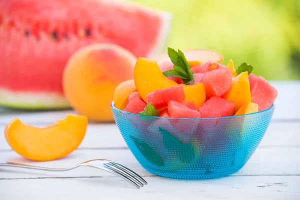 slices of fresh peach and watermelon in bowl