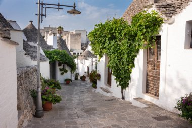Alberobello, Apulian bölgesinde çiçekli tipik trulli evler, İtalya