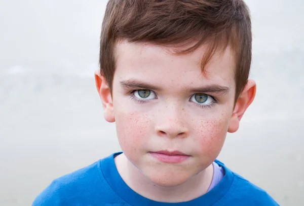 portrait of a boy with a sad face