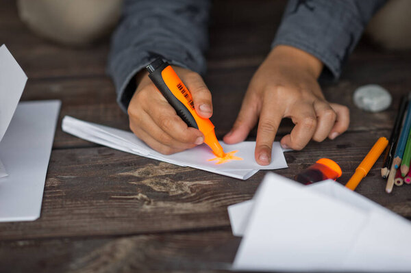 Dad and son are folding airplanes sitting on the edge of the terrace.