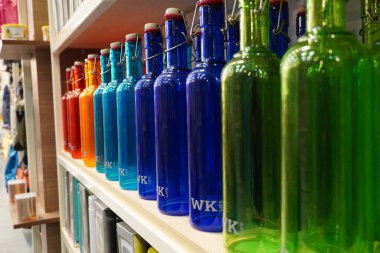Satılık raflarda üst üste yığılmış çeşitli renkli şişeler. Dekorasyon konsepti. Antika şişe süpermarkette satılıktır. Şeffaf su şişeleri. Bangalore Hindistan Ağustos 2021