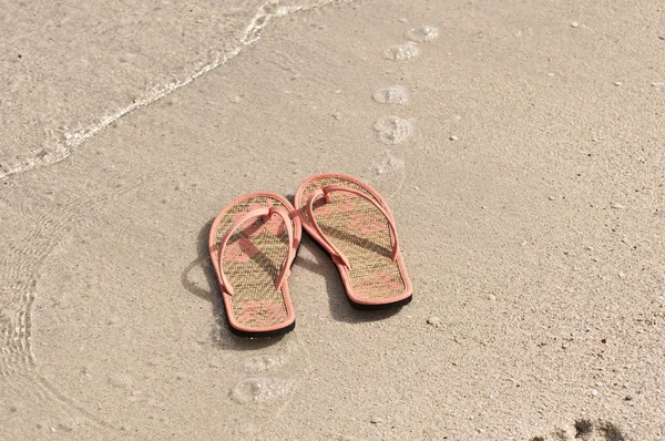 Flip-flops on a beach Stock Image