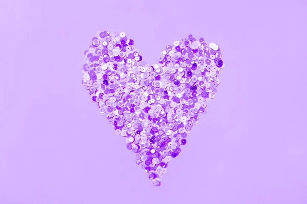 Heart made of multicolored sequins confetti on violet very peri background. Flat festive composition copy space — 스톡 사진