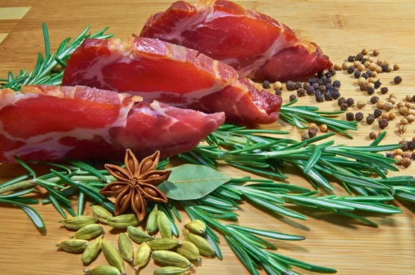 Sliced meat with rosemary — Stock Photo, Image