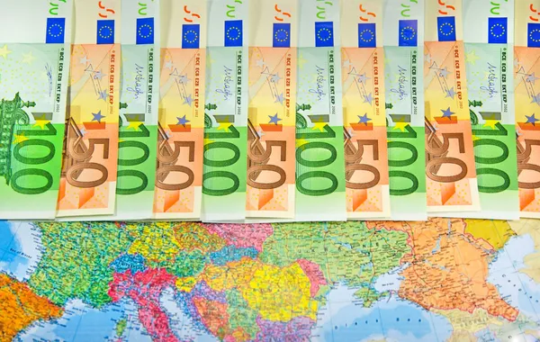 Euro bills in a row on the map — Stock Photo, Image