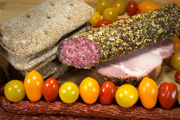 Meat and bread with colored tomatoes — Stock Photo, Image