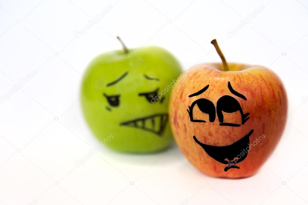 Two cartoon-faced apples on white