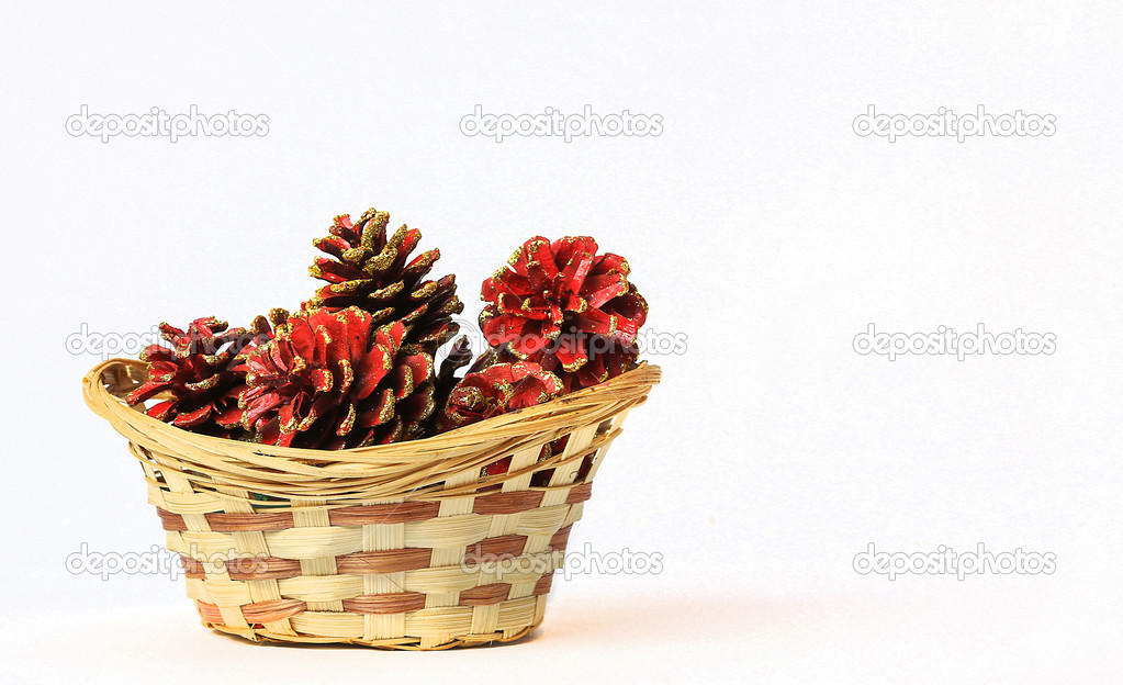 Christmas basket with pine cones isolated