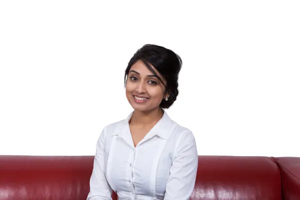 Smiling businesswoman sitting on sofa — Stock Photo, Image