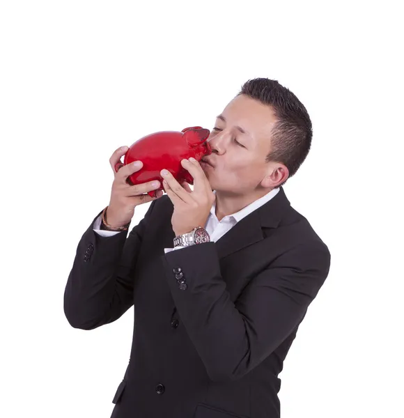 Businessman kissing his piggy bank — Stock Photo, Image