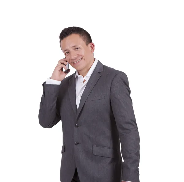 Smiling young businessman talking on cell phone — Stock Photo, Image