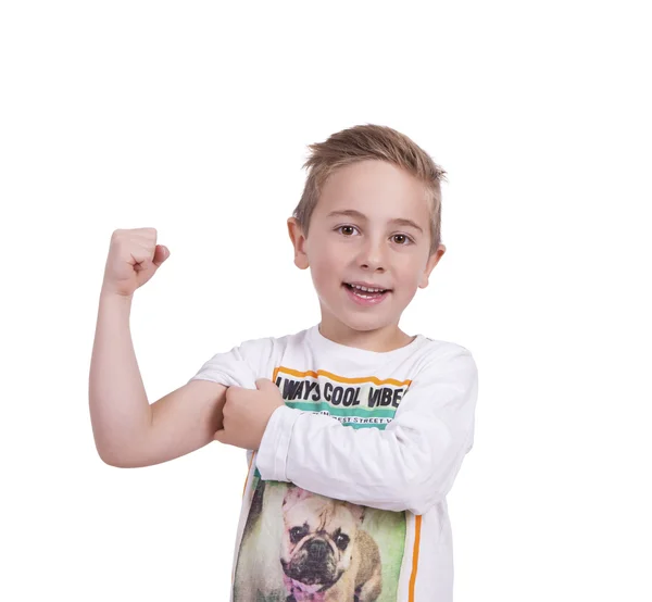 Smiling elementary boy flexing biceps — Stock Photo, Image