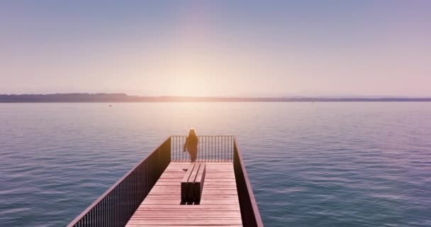 Aerial Video Happy Carefree Woman Standing Pier Looking Sunset — Stockvideo