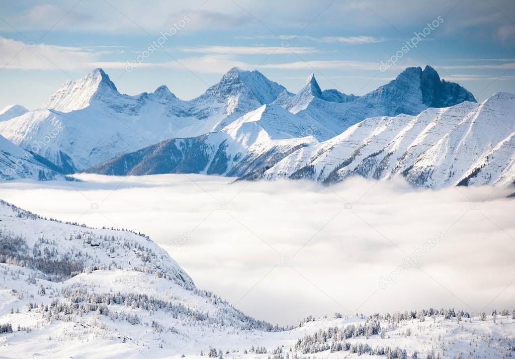 snowy high mountains of the Alps in the fog