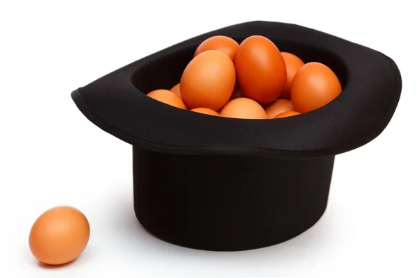 Colored eggs in a black hat — Stock Photo, Image