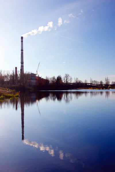 Landscape with water and smoking chimneys — Stock Photo, Image